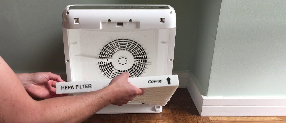 Person Opening a Coway Air Purifier